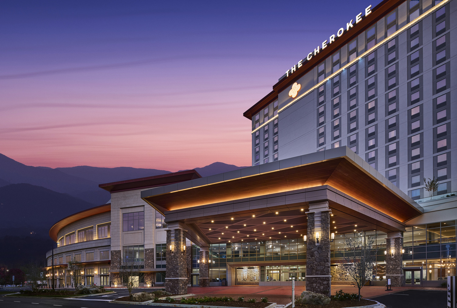 A large hotel with a mountain in the background.