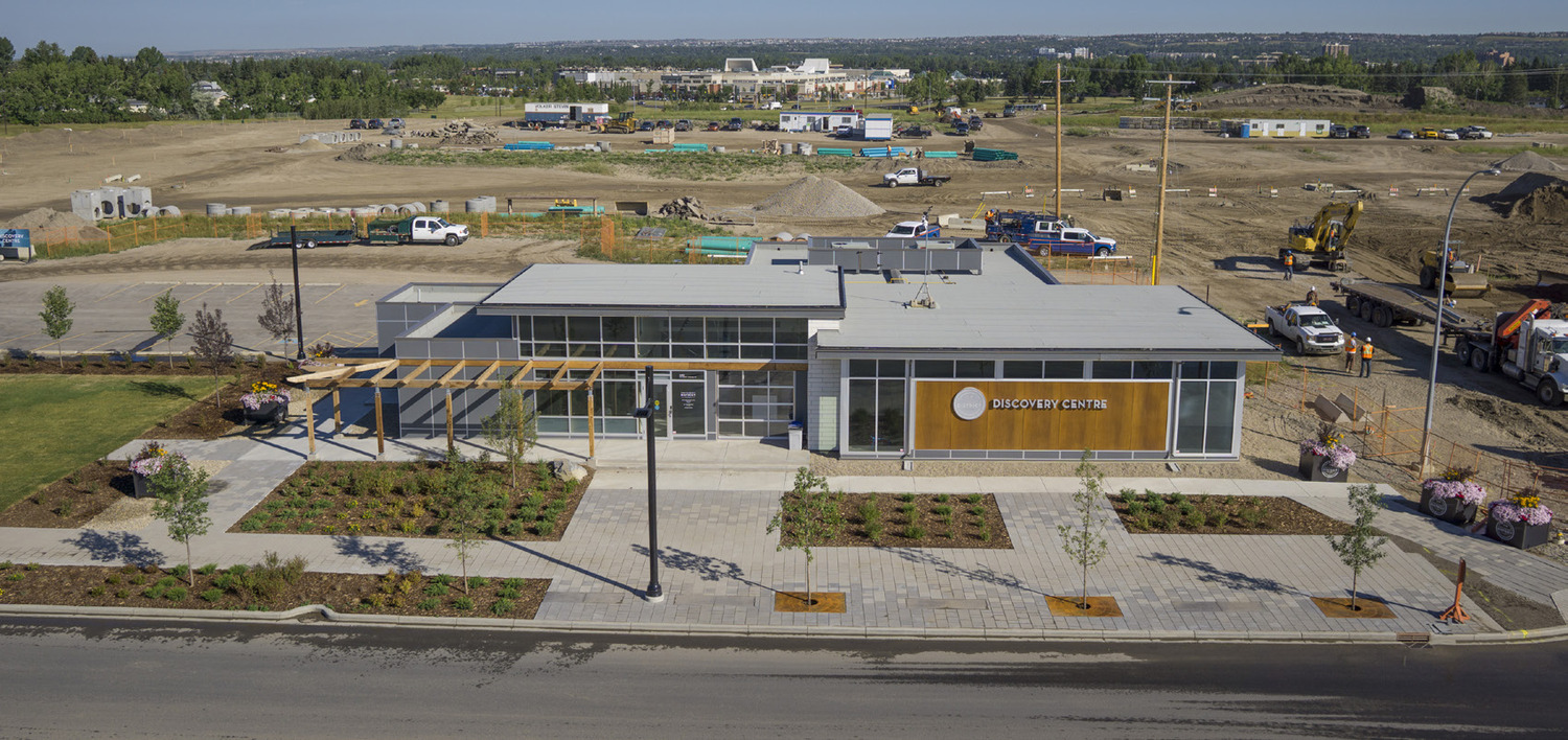 An aerial view of a construction site with a building in the background.