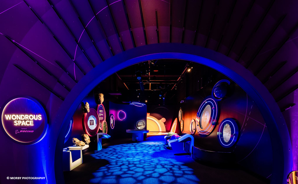 A room with a purple light and a blue wall.