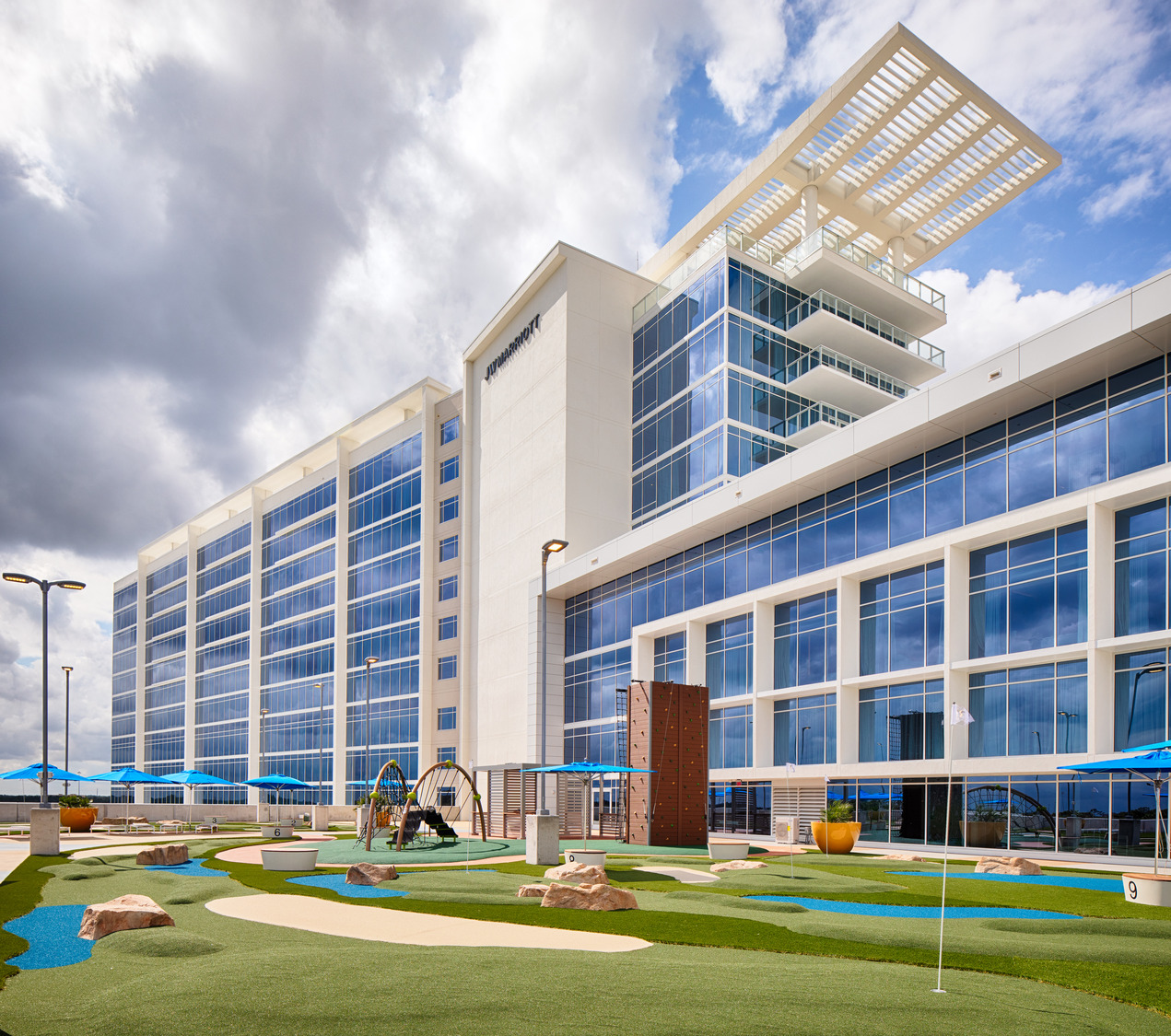 A building with a golf course in front of it.