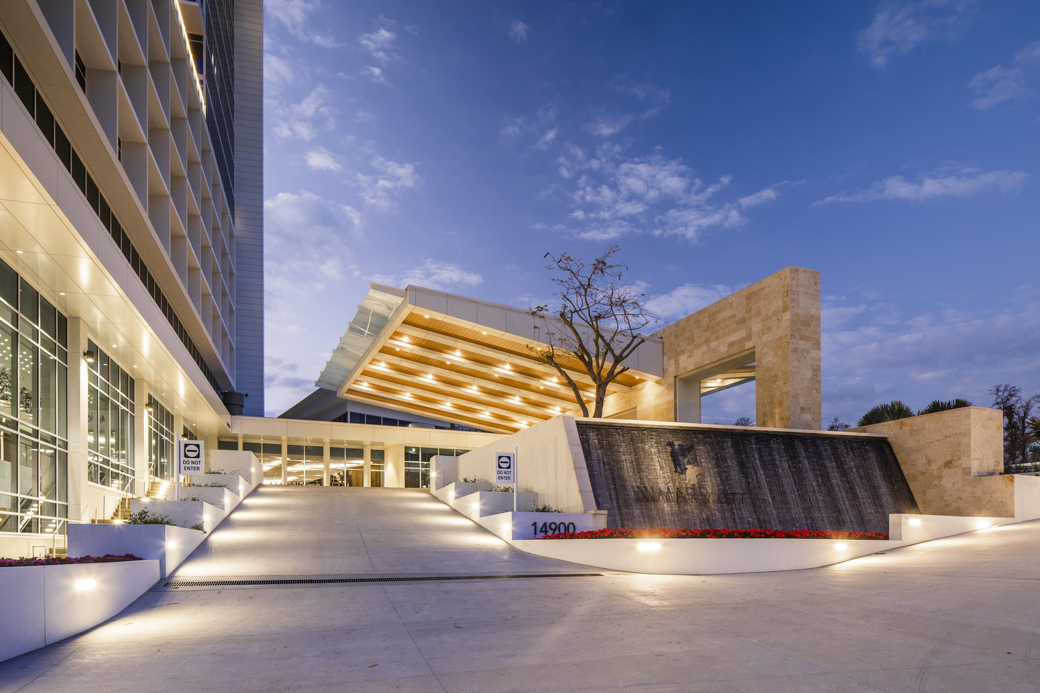 The entrance to a hotel at dusk.