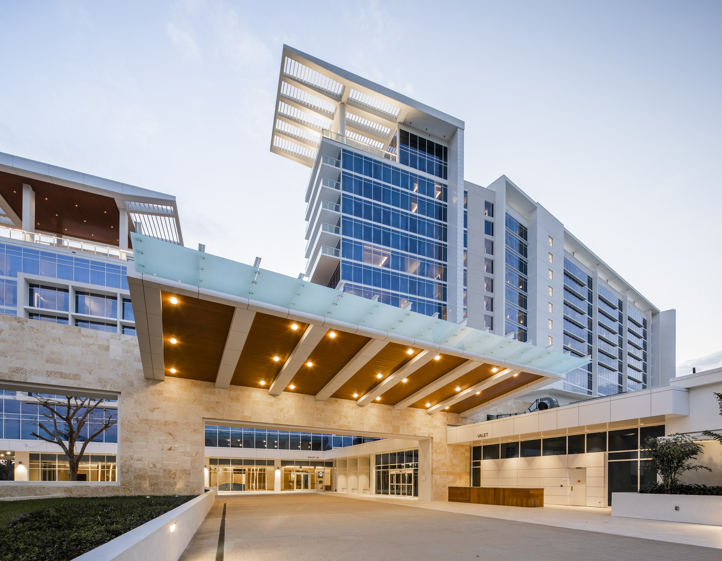 The entrance to a large building with a glass roof.