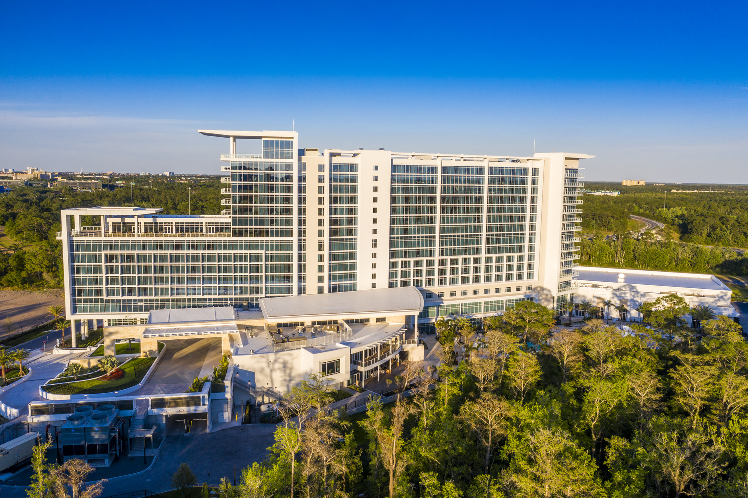 An aerial view of a hotel in the middle of a forest.