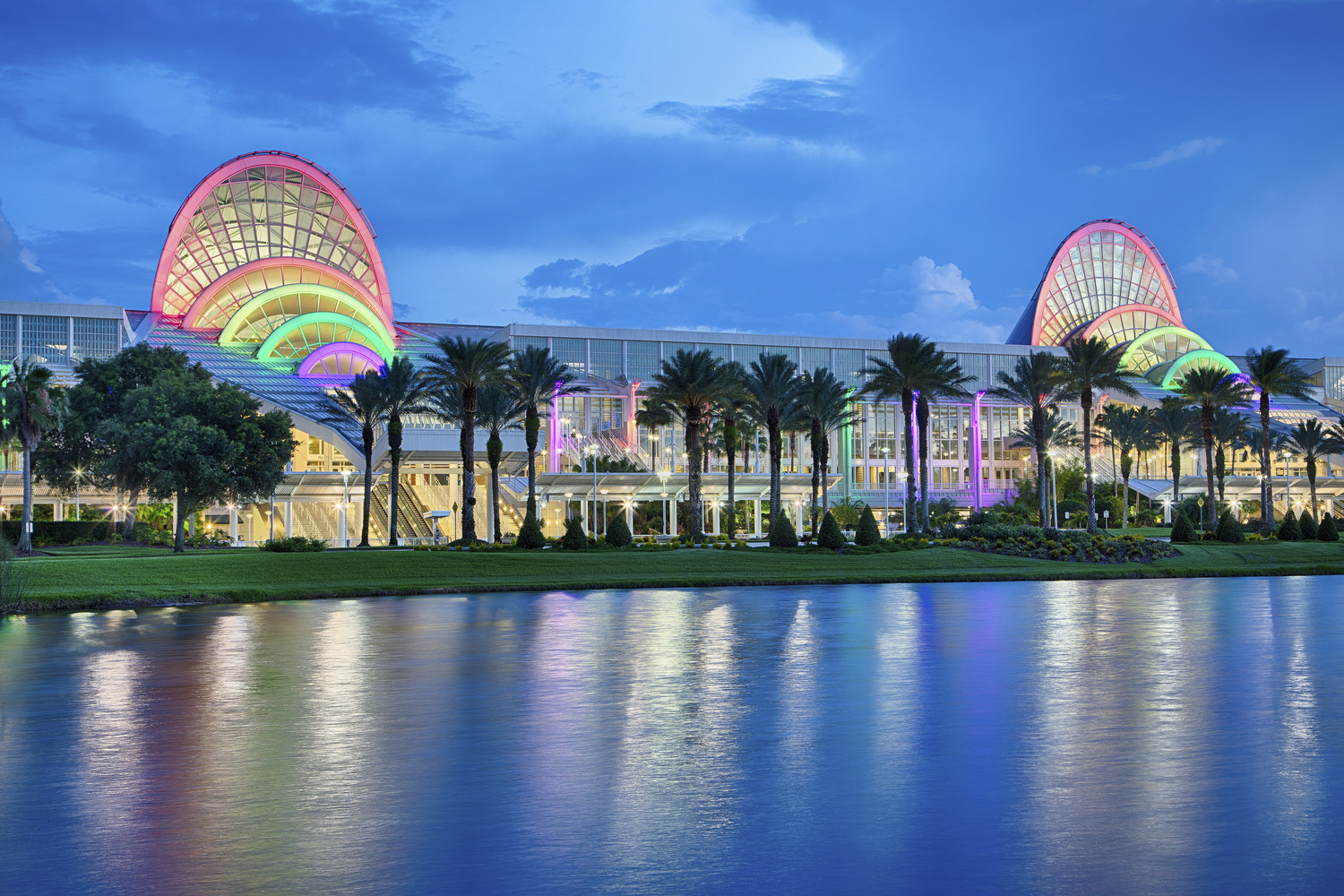 The orlando convention center is lit up at night.