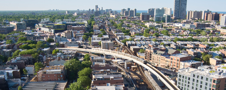 An aerial view of a city with train tracks and buildings.