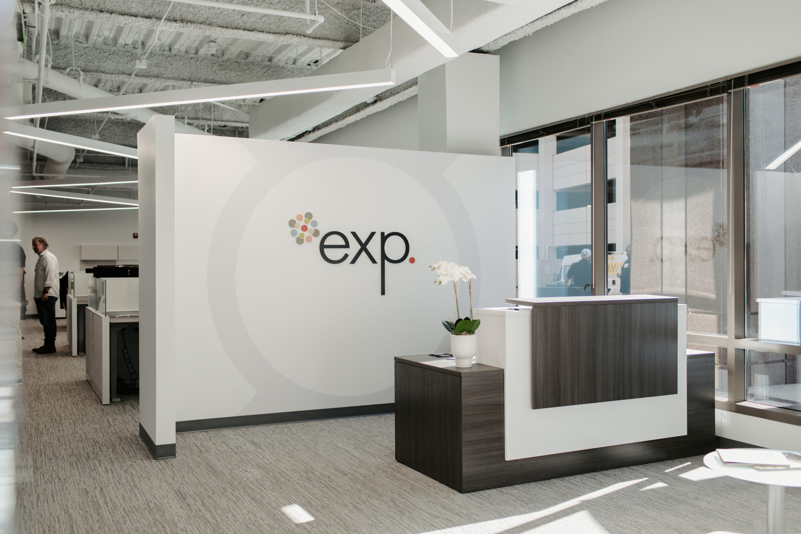 Modern office reception area with company logo on the wall.