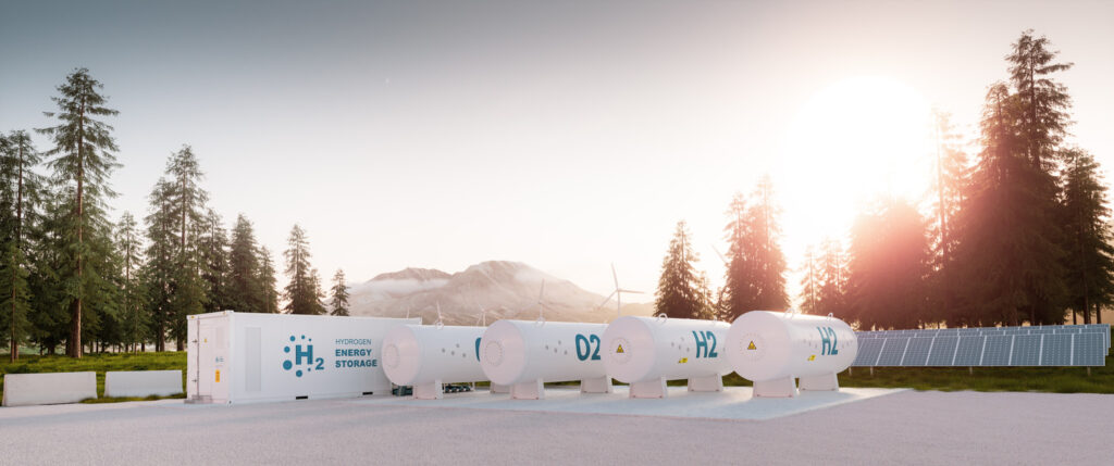 Hydrogen energy storage system with cylindrical tanks in an outdoor setting at sunset.