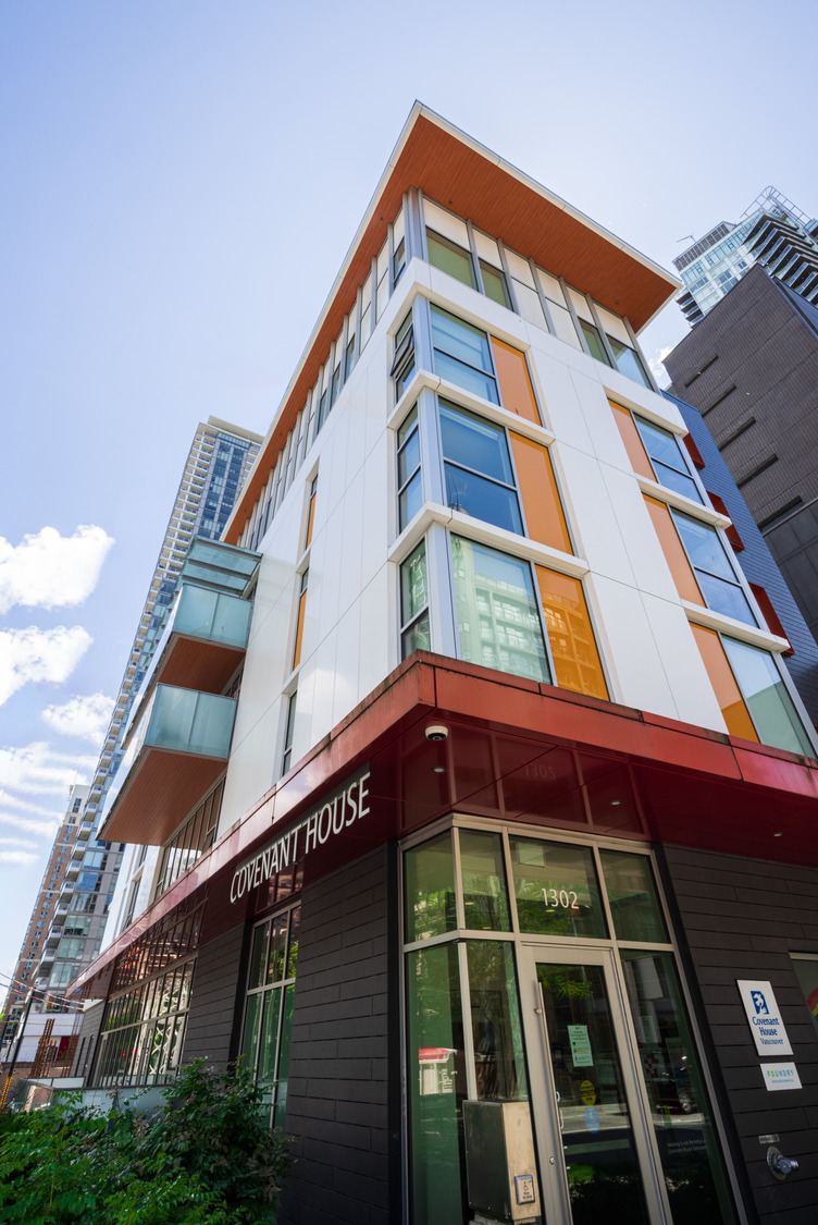 A modern multi-story building with large windows, labeled 