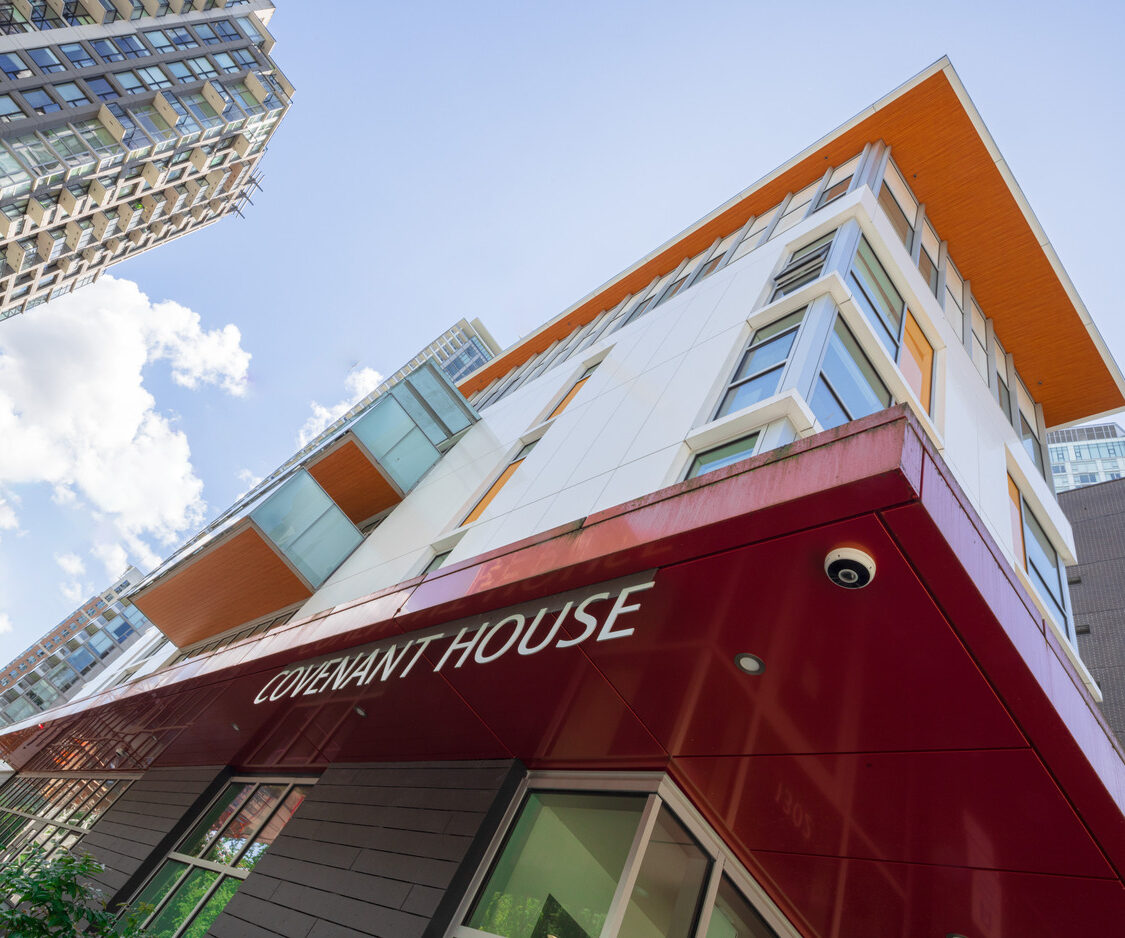 A modern building with a red overhang labeled 