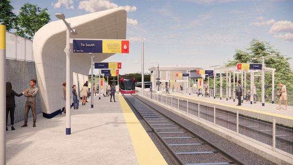 A modern light rail station with platforms on both sides, passengers waiting, and a train approaching on the tracks under a partly cloudy sky.