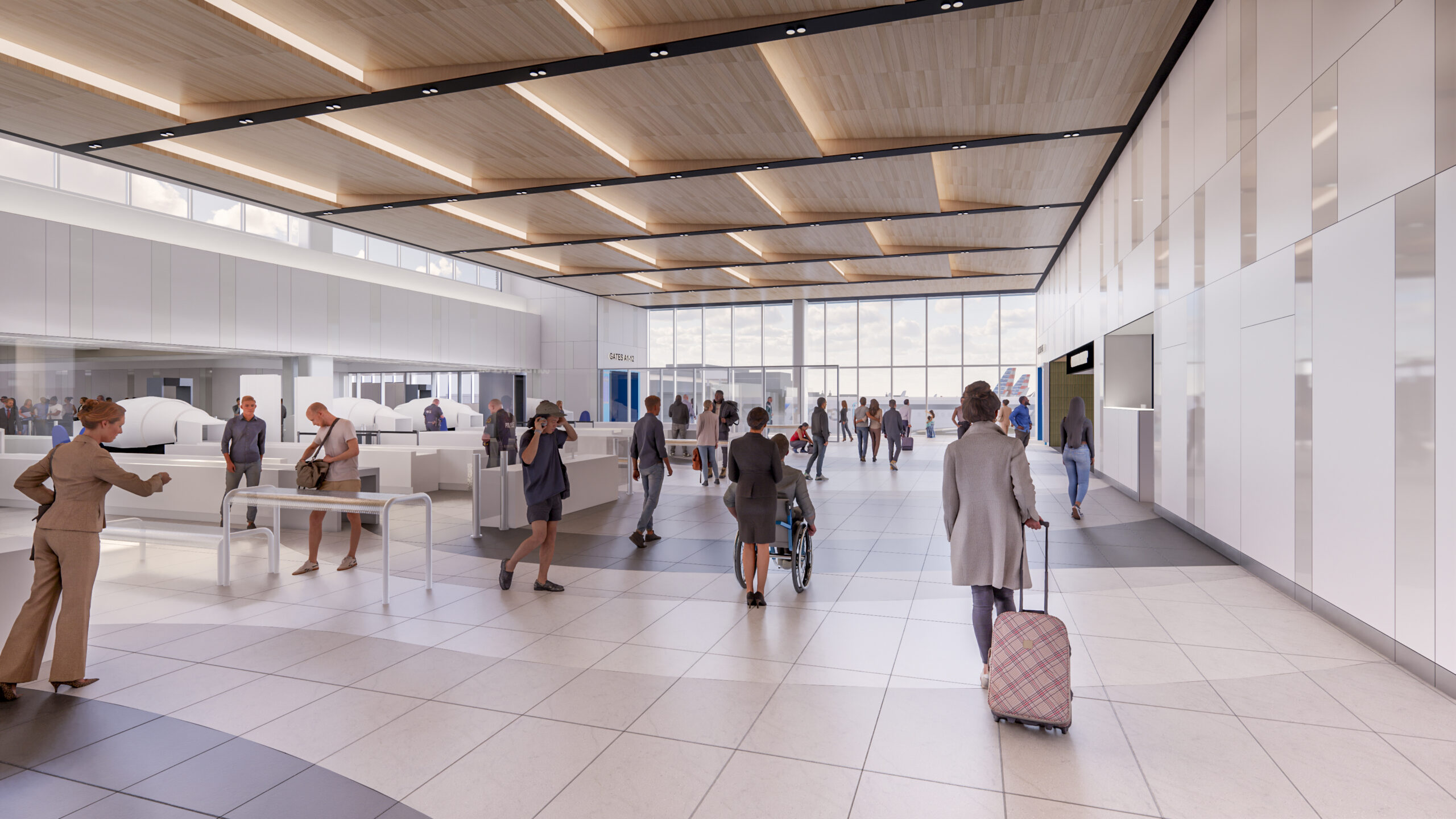 People walking through a modern, brightly lit airport terminal with large windows, including a person using a wheelchair and a traveler with rolling luggage.
